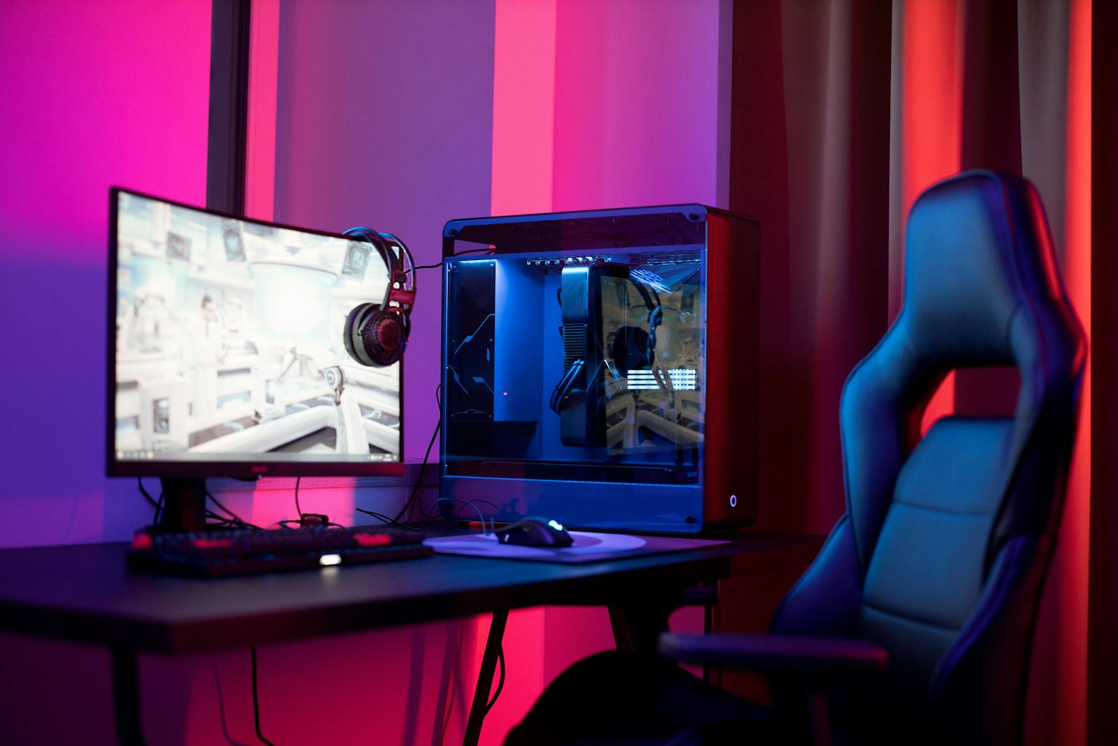 Gaming setup with neon lighting and widescreen monitor
