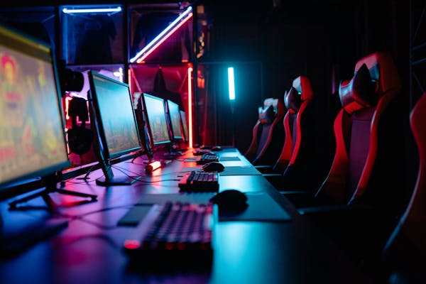 Gaming room with neon lights and multiple PCs