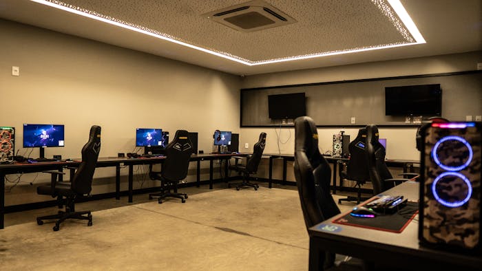 Simple computer gaming room setup with multiple PCs and chairs